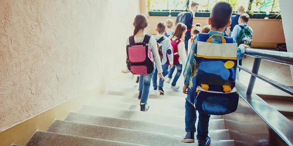 Kids walking down the steps in school