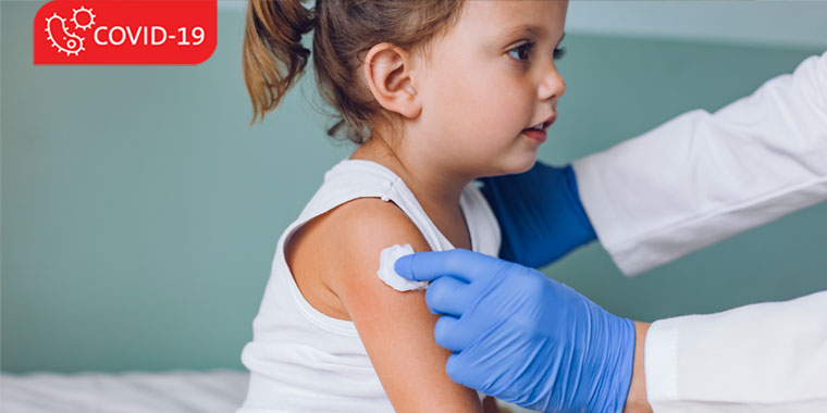 Young child at a doctor's office, preparing for a vaccine.